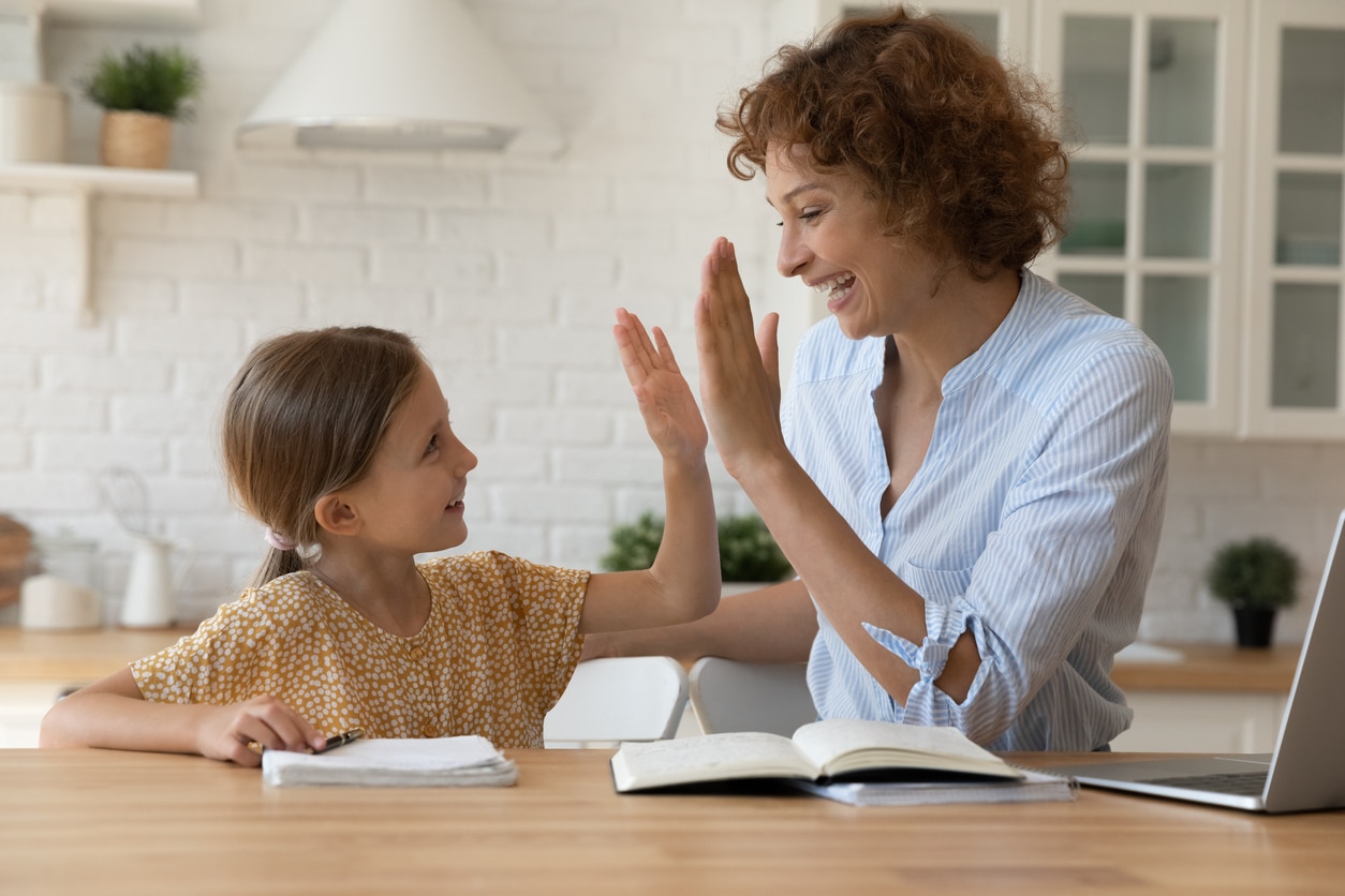 Caregiver and Child giving high-5s