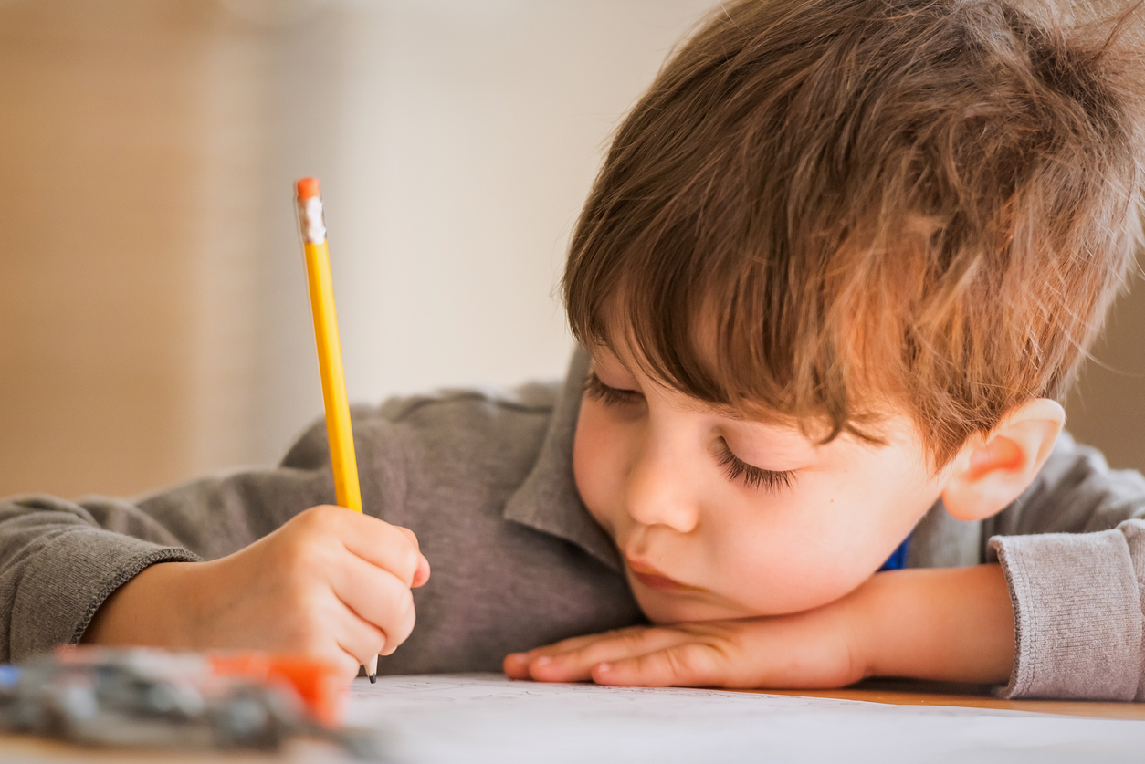 Little boy holding a pencil